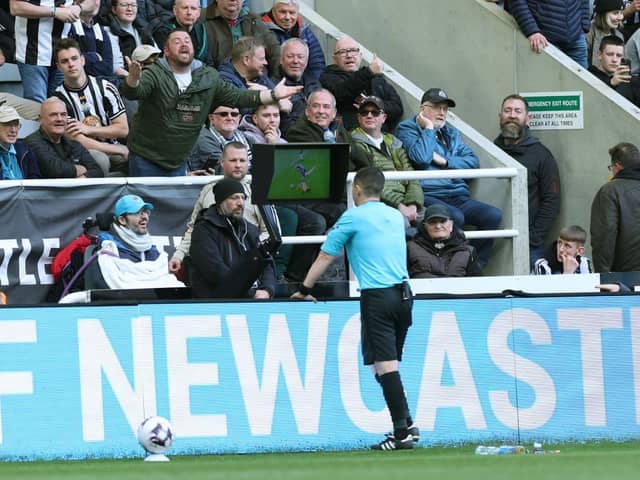 Tony Harrington checks the Video Assistant Referee screen during the Premier League match between Newcastle United and Sheffield United at St. James Park