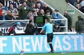 Tony Harrington checks the Video Assistant Referee screen during the Premier League match between Newcastle United and Sheffield United at St. James Park