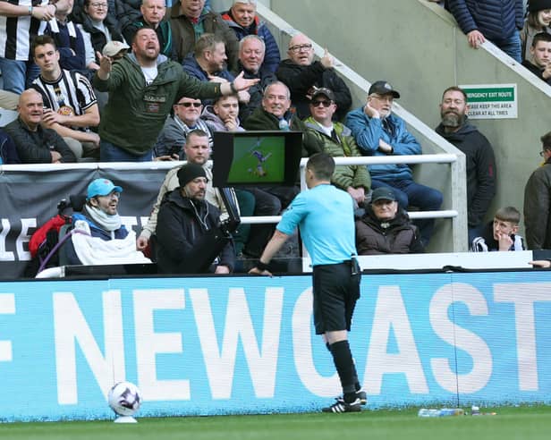 Tony Harrington checks the Video Assistant Referee screen during the Premier League match between Newcastle United and Sheffield United at St. James Park