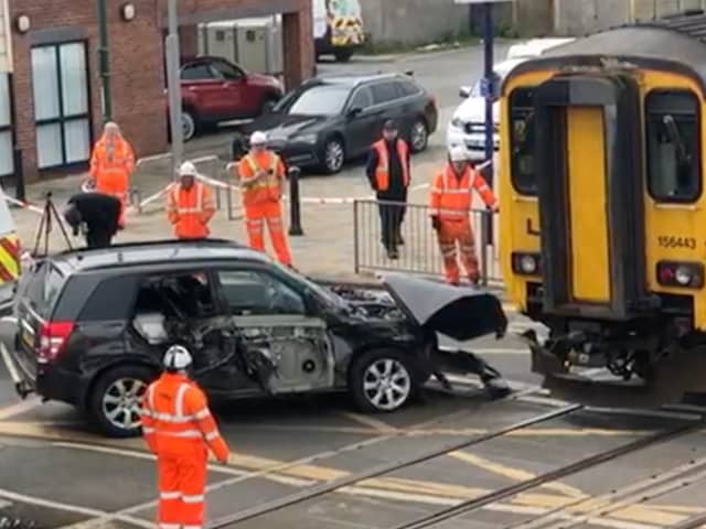 Network Rail staff work to remove an SUV from the track after it was hit by a train on a crossing at Redcar Central, Middlesbrough, on Wednesday May 1 2024. 