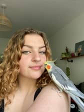 Grace Robinson, 19, with her pet cockatiel Kiki.