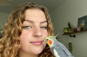 Grace Robinson, 19, with her pet cockatiel Kiki.