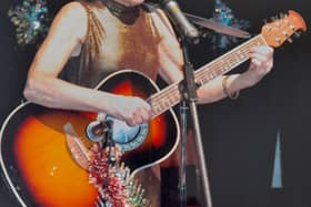 Helen Russell performing with her guitar