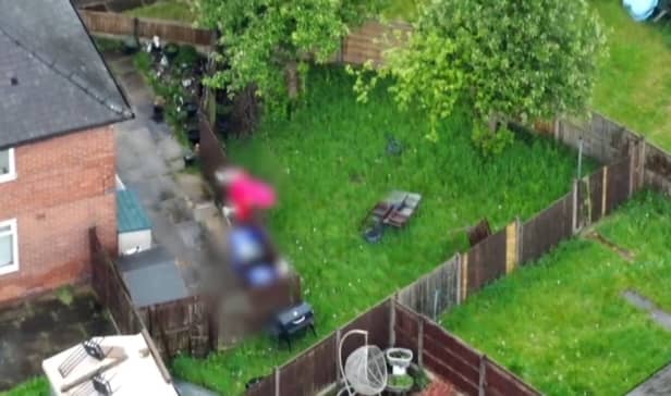 Suspect jumps fences in dressing gown to try and flee police.