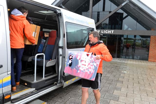 Richard and Noah loading the donated kit into the school's minibus ready to be flown out to Kenya.