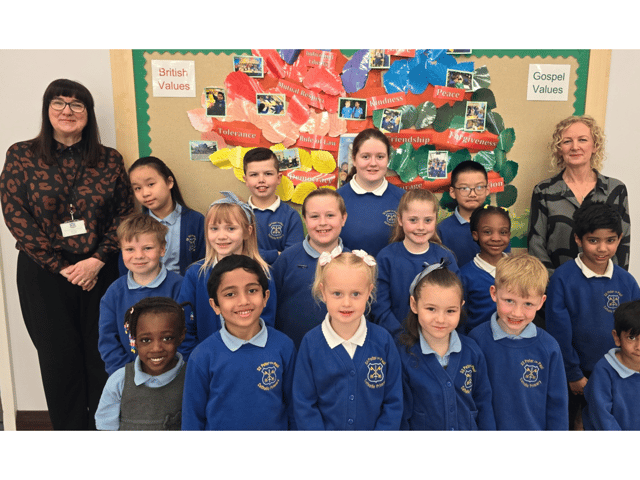 SS Peter and Paul Catholic Primary School headteacher, Maria Butt (left) with pupils from the school following another successful Ofsted rating.