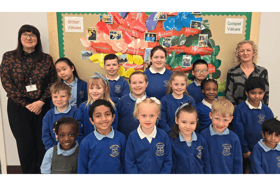 SS Peter and Paul Catholic Primary School headteacher, Maria Butt (left) with pupils from the school following another successful Ofsted rating.