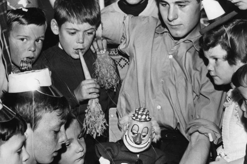 Fred Finch introduces one of his father's puppets to a group of children at a 1963 party held for them by the Westoe Mechanics Social Club in the Boldon Lane Community Centre. 