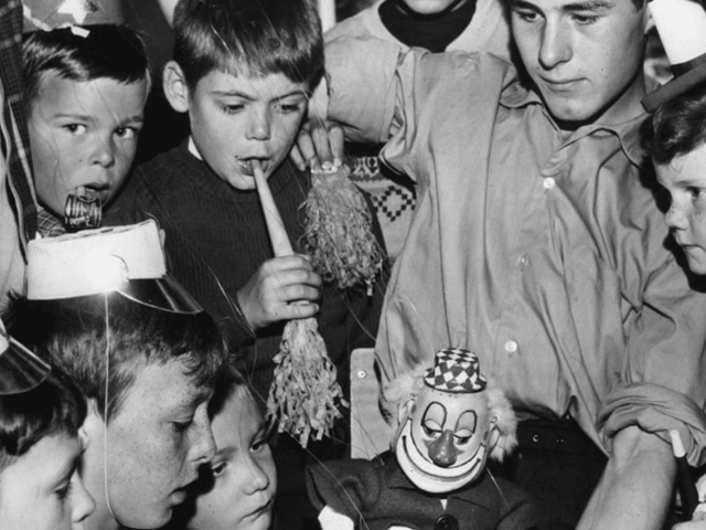 Fred Finch introduces one of his father's puppets to a group of children at a 1963 party held for them by the Westoe Mechanics Social Club in the Boldon Lane Community Centre. 