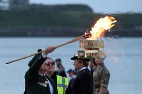 Veteran Joe Mills, Chair of South Tyneside NAAFI Break, lights beacon on Littlehaven Beach.