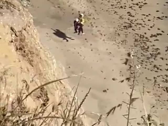 Surfer rescued from beach after spelling “Help” on the sand.