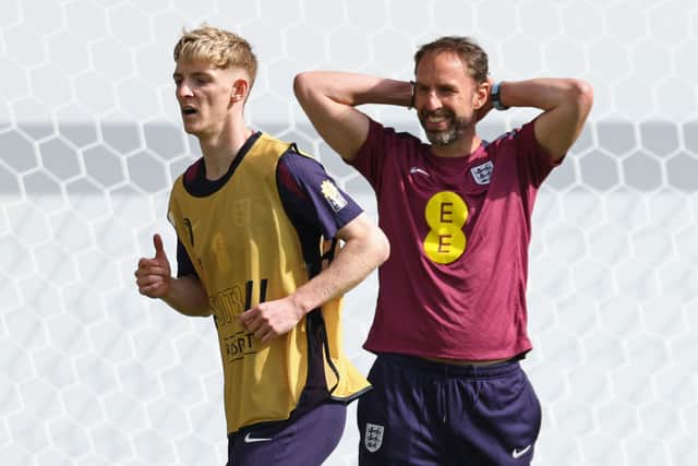 England's manager Gareth Southgate (R) reacts next to his team player Anthony Gordon during a training session in Jena, eastern Germany on June 11, 2024, ahead of the UEFA Euro 2024 football championship. (Photo by Adrian DENNIS / AFP) (Photo by ADRIAN DENNIS/AFP via Getty Images)