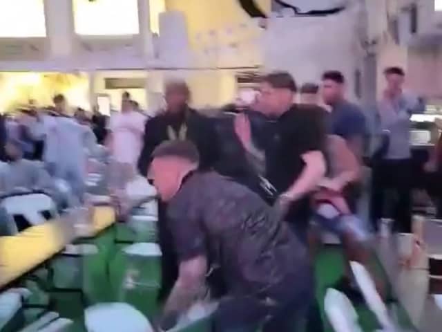 Men can be seen throwing chairs across the room at the Winter Gardens first Euros Fanzone match. 