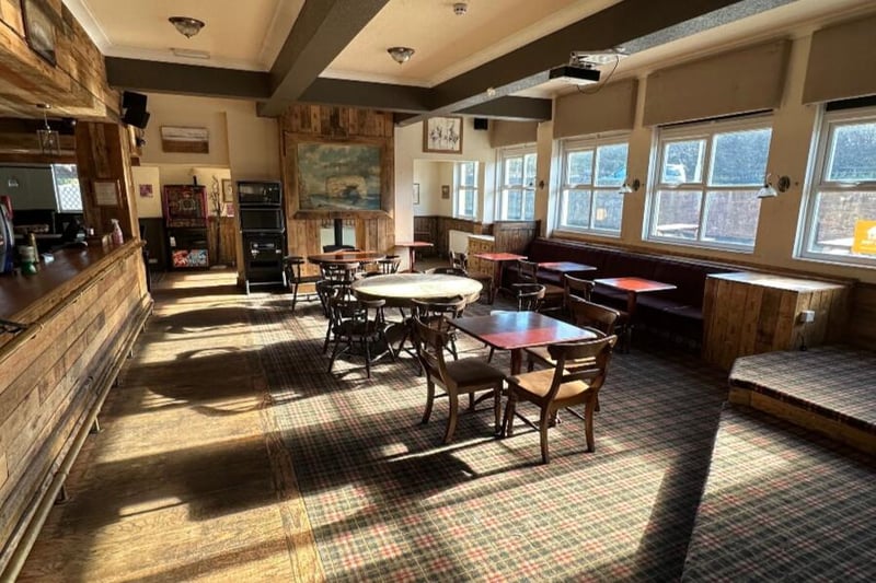 The bar area is well lit with plenty of sunshine coming through the windows.
