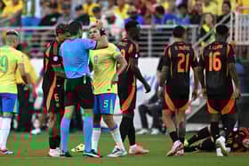 Venezuelan referee Jesus Valenzuela shows a yellow card to Brazil's midfielder #05 Bruno Guimaraes during the Conmebol 2024 Copa America tournament group D football match between Brazil and Colombia at Levi's Stadium in Santa Clara, California on July 2, 2024. (Photo by Patrick T. Fallon / AFP) (Photo by PATRICK T. FALLON/AFP via Getty Images)