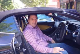 Conman Stephen Rae pictured in his Aston Martin.