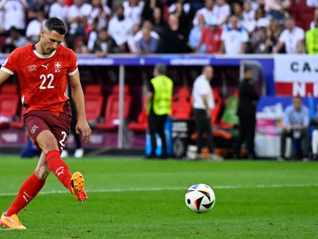 Switzerland's defender #22 Fabian Schaer shoots and scores in the penalty shootout during the UEFA Euro 2024 quarter-final football match between England and Switzerland at the Duesseldorf Arena in Duesseldorf on July 6, 2024. (Photo by INA FASSBENDER/AFP via Getty Images)