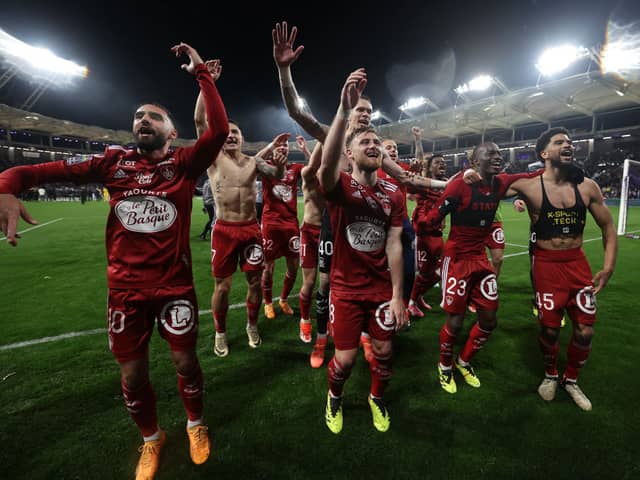 Stade Brestois' players celebrate after winning the French L1 football match between Toulouse (TFC) and Stade Brestois 29 (Brest) at the Stadium TFC in Toulouse, south-western France, on May 19, 2024