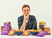 Aldi Chief Crisp Tasting Officer George Critchley with a range of Aldi own brand crisps. (Photo: PR Handout)