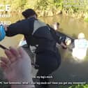 Woman is rescued from neck-level flood water in submerged car.