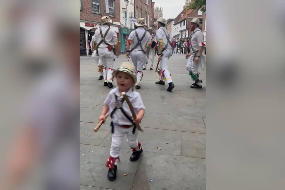 Two-year-old Toby dances along with father’s Morris dance group.