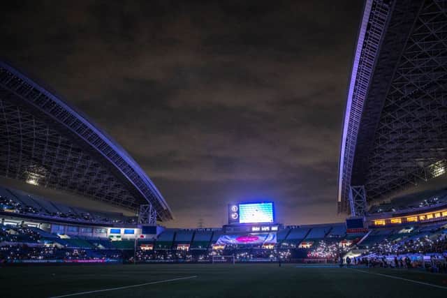 A general view shows spectators using their mobile phones' torches before the FIFA World Cup Qatar 2022 Asian zone qualification football match between Japan and China at Saitama Stadium in Saitama on January 27, 2022. (Photo by Philip FONG / AFP) (Photo by PHILIP FONG/AFP via Getty Images)