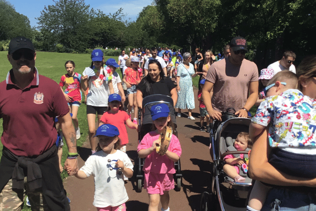 The school community walked through the local area singing songs, playing instruments and holding banners.