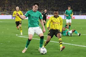 Tino Livramento of Newcastle United is challenged by Youssoufa Moukoko of Borussia Dortmund