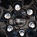The Ford logo is shown on the wheel of a car. (Photo by Scott Olson/Getty Images)