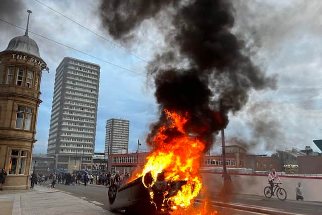 A car is toppled over and set alight during scenes of disorder in Sunderland which followed on from rioting in Hartlepool earlier in the same week after the Southport stabbing tragedy.