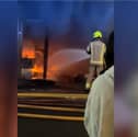 Sixty firefighters tackle blaze at kosher restaurant and flats.