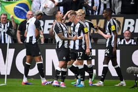 Bruno Guimaraes of Newcastle United celebrates after Joelinton of Newcastle United (obscured) scores his team's first goal during the Premier League match between Newcastle United FC and Southampton FC at St James' Park on August 17, 2024 in Newcastle upon Tyne, England.