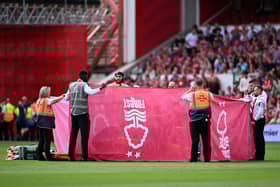 Response team staff hold up a cover as Antoine Semenyo of AFC Bournemouth (obscured) and Danilo of Nottingham Forest (obscured) receive medical treatment during the Premier League match between Nottingham Forest FC and AFC Bournemouth at City Ground on August 17, 2024 in Nottingham, England. 
