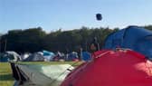 Tent hurtles across sky as Storm Lilian hits Leeds Festival.