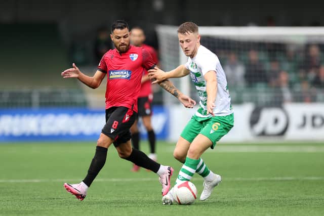 Jack Bodenham of The New Saints FC holds off Caique Augusto of Decic during the UEFA Champions League First Qualifying Round 1st leg