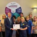 Ken Bremner, chief executive at South Tyneside and Sunderland NHS Foundation Trust, presenting Ward 8's manager Ann Callaghan and her team with their Ward Accreditation certificate.