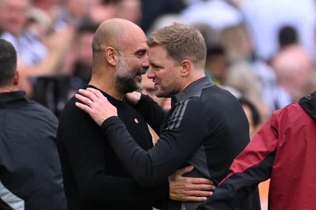 Eddie Howe and Pep Guardiola speak at St James’ Park. 