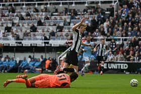 Newcastle United's English midfielder #10 Anthony Gordon is brought down for a penalty by Manchester City's Brazilian goalkeeper #31 Ederson during the English Premier League football match between Newcastle United and Manchester City at St James' Park in Newcastle-upon-Tyne, north-east England on September 28, 2024. (Photo by Oli SCARFF / AFP)