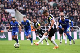 Fabian Schar of Newcastle United scores his team's first goal from the penalty spot during the Carabao Cup Third Round match between Newcastle United and AFC Wimbledon at The Cherry Red Records Stadium on October 01, 2024 in Wimbledon, England. (Photo by George Wood/Getty Images)