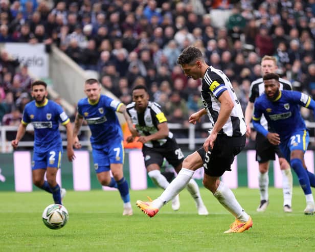 Fabian Schar of Newcastle United scores his team's first goal from the penalty spot during the Carabao Cup Third Round match between Newcastle United and AFC Wimbledon at The Cherry Red Records Stadium on October 01, 2024 in Wimbledon, England. (Photo by George Wood/Getty Images)