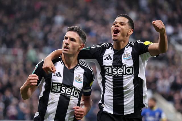 Fabian Schar of Newcastle United celebrates scoring his team's first goal with teammate William Osula during the Carabao Cup Third Round match between Newcastle United and AFC Wimbledon at The Cherry Red Records Stadium on October 01, 2024 in Wimbledon, England. (Photo by George Wood/Getty Images)