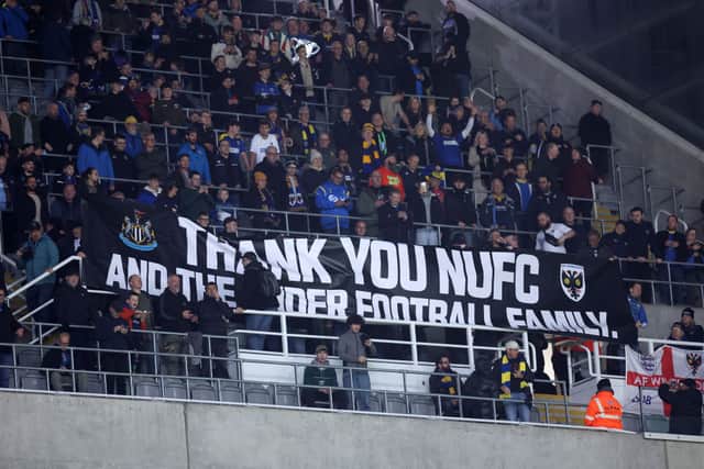 Fans of AFC Wimbledon display a banner thanking Newcastle United. (Photo by George Wood/Getty Images)