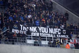 Fans of AFC Wimbledon display a banner thanking Newcastle United. (Photo by George Wood/Getty Images)