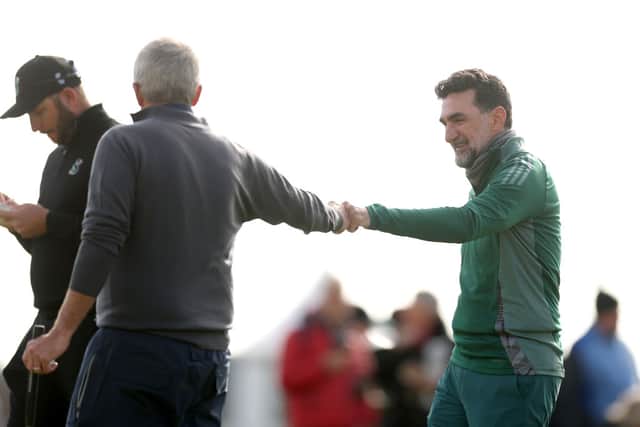 Yasir Al-Rumayyan, Governor of Saudi Arabia's Public Investment Fund fist bumps Jay Monahan, Commissioner of the PGA Tour during day one of the Alfred Dunhill Links Championship 2024 at Carnoustie Golf Links on October 03, 2024 in Carnoustie, Scotland. (Photo by Richard Heathcote/Getty Images)