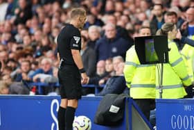 Referee Craig Pawson reviews the VAR monitor during the Premier League match between Everton FC and Newcastle United FC at Goodison Park on October 05, 2024 in Liverpool, England. (Photo by Jan Kruger/Getty Images)