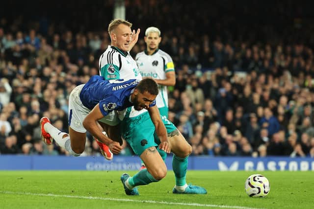 Dominic Calvert-Lewin of Everton is challenged by Dan Burn of Newcastle United during the Premier League match between Everton FC and Newcastle United FC at Goodison Park on October 05, 2024 in Liverpool, England. (Photo by Matt McNulty/Getty Images)