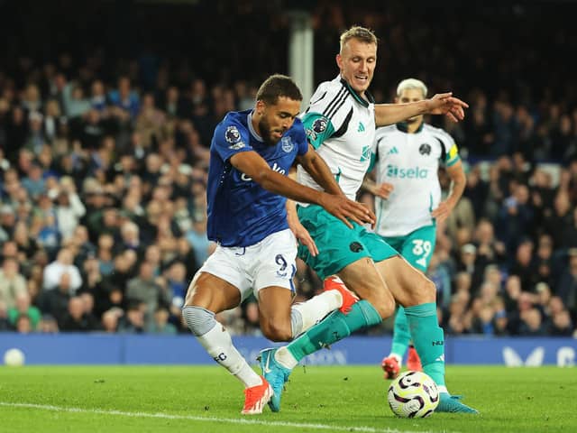 Dominic Calvert-Lewin of Everton is challenged by Dan Burn of Newcastle United during the Premier League match. Photo by Matt McNulty/Getty Images)