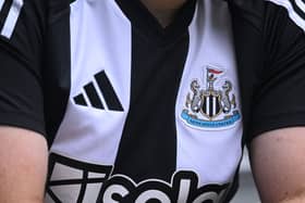  The Adidas logo and club badge are seen on the shirt of the new home kit during the Premier League match between Newcastle United FC and Southampton FC at St James' Park on August 17, 2024 in Newcastle upon Tyne, England. (Photo by Stu Forster/Getty Images)