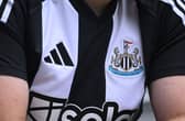  The Adidas logo and club badge are seen on the shirt of the new home kit during the Premier League match between Newcastle United FC and Southampton FC at St James' Park on August 17, 2024 in Newcastle upon Tyne, England. (Photo by Stu Forster/Getty Images)