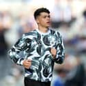 Lewis Miley of Newcastle United warms up prior to the Premier League match between Newcastle United FC and Brighton & Hove Albion FC at St James' Park on October 19, 2024 in Newcastle upon Tyne, England. (Photo by George Wood/Getty Images)